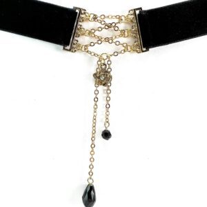 Elegant black velvet choker with gold chains and black teardrop pendants.