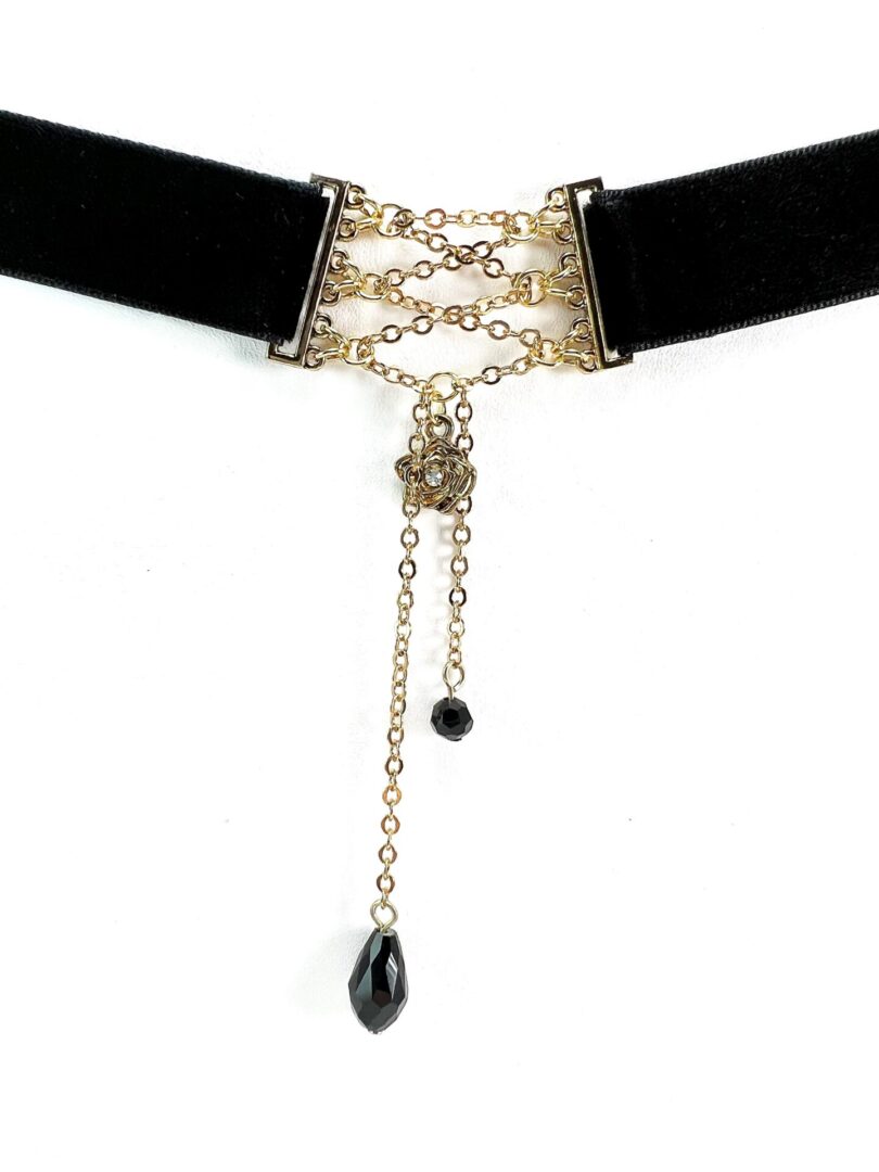 Elegant black velvet choker with gold chains and black teardrop pendants.