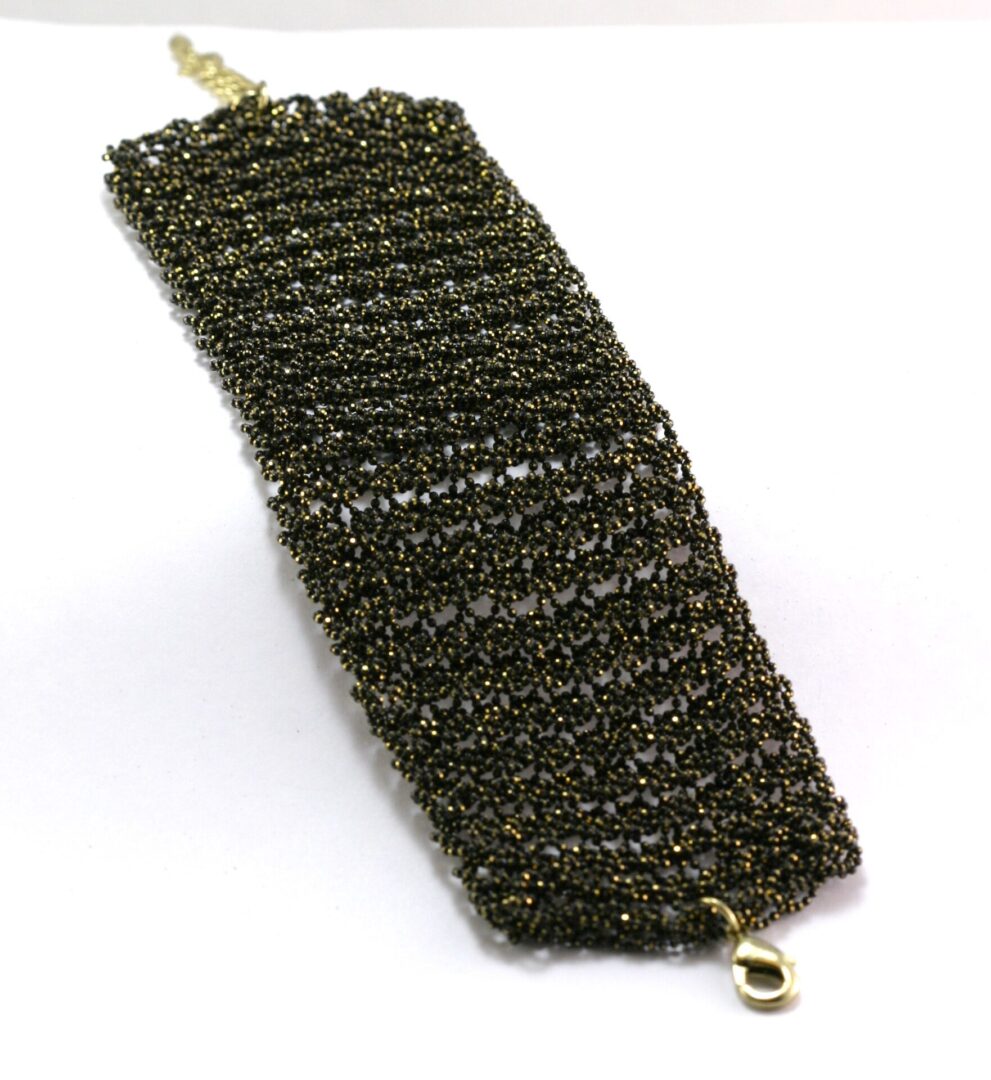 Metal scrubber pad for cleaning dishes and surfaces.