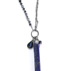 Silver chain necklace with a blue pendant and small charm.