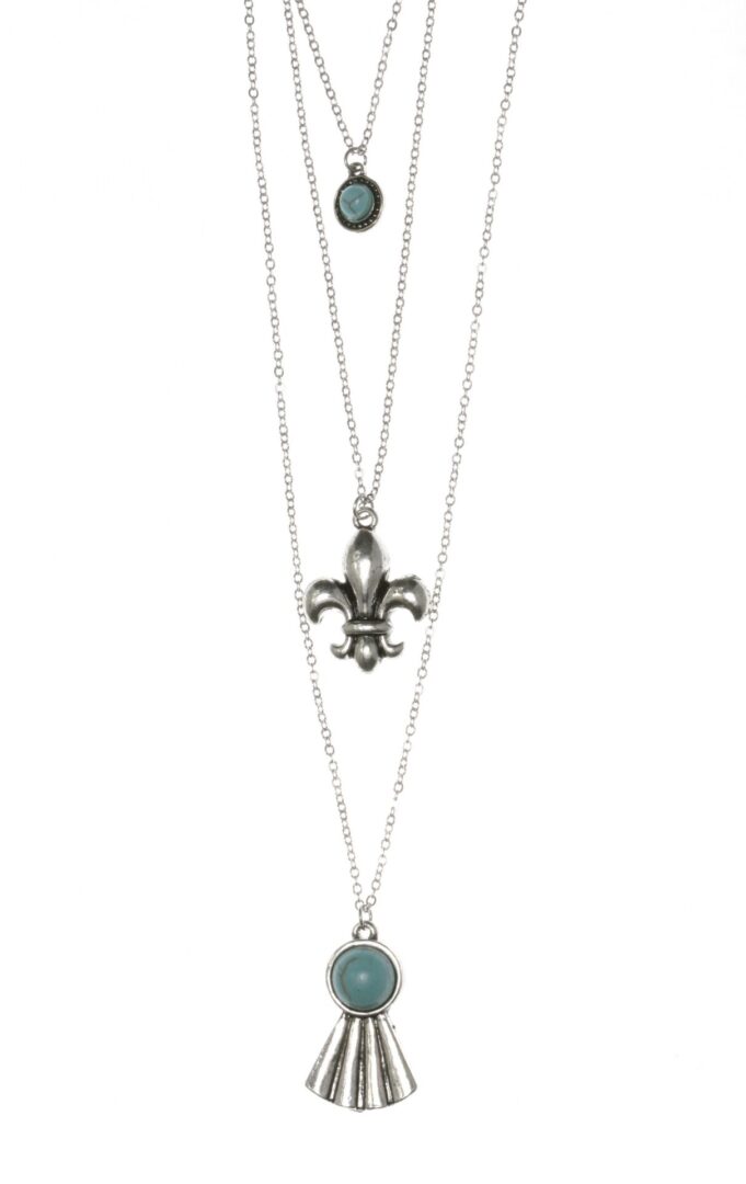 Layered silver necklaces with fleur-de-lis and turquoise pendants.