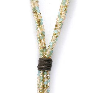 Close-up of a beaded necklace with a dark wrap detail.