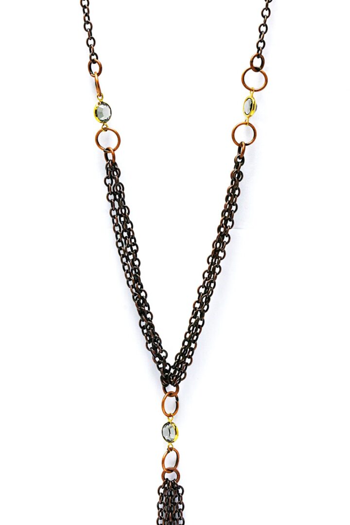 Elegant black chain necklace with gold and green bead accents.