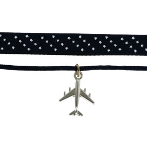 Choker necklace with a plane charm and polka dot ribbon.