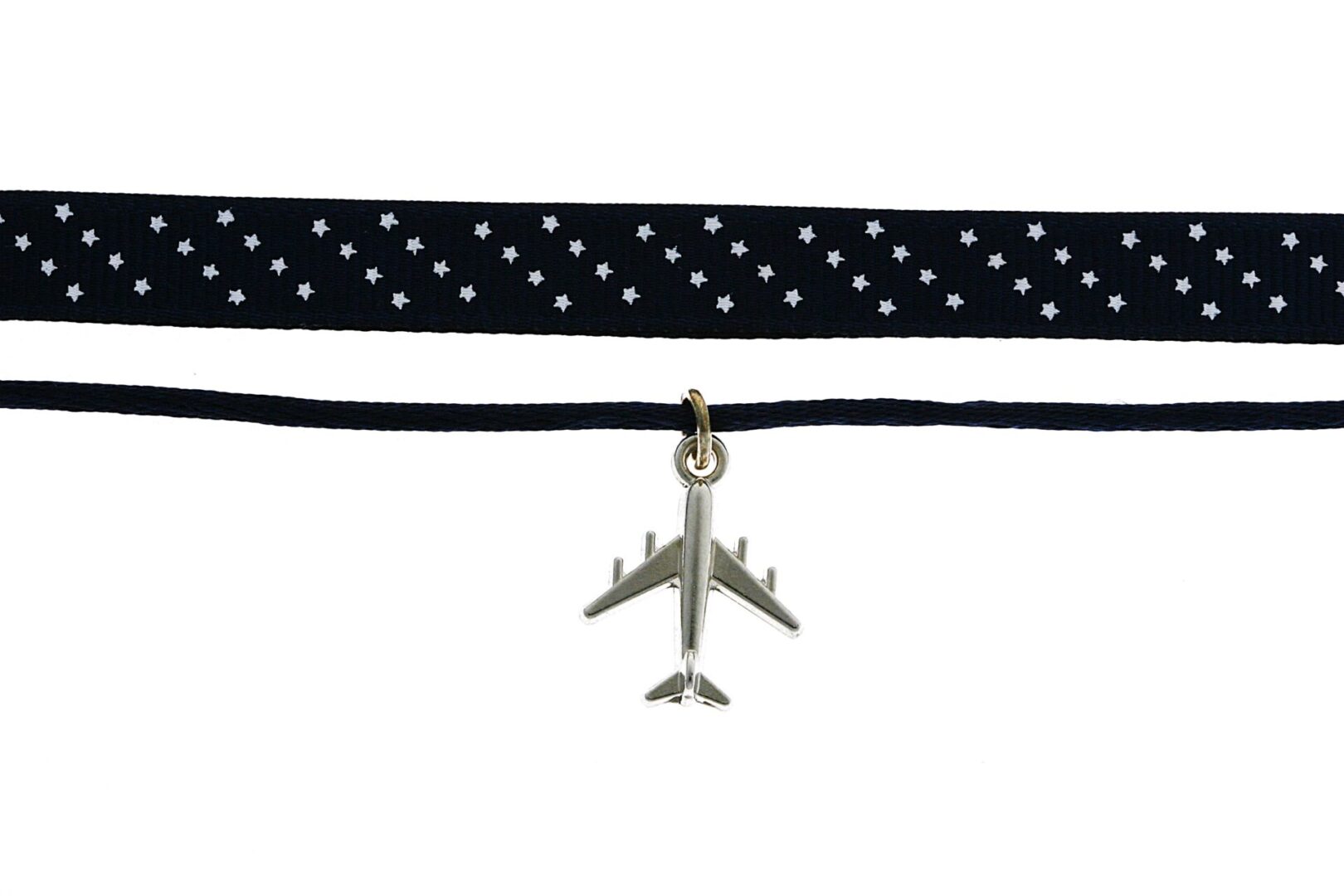 Choker necklace with a plane charm and polka dot ribbon.