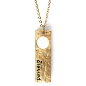 Gold pendant necklace with 'Blessed' engraving and a circular cutout.