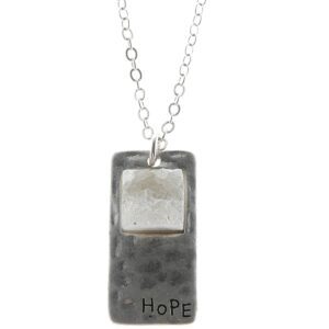 Silver necklace pendant with the word 'Hope'.