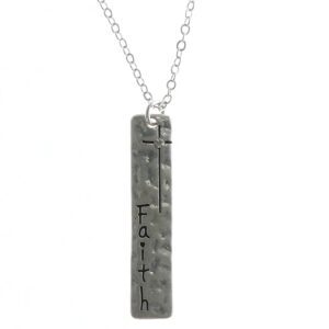 A silver pendant necklace with the word 'faith' engraved.