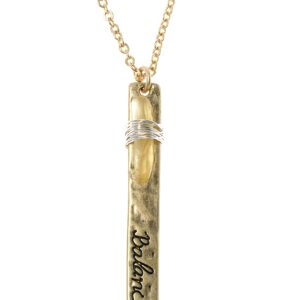 Gold pendant necklace with engraved text and a decorative ring.