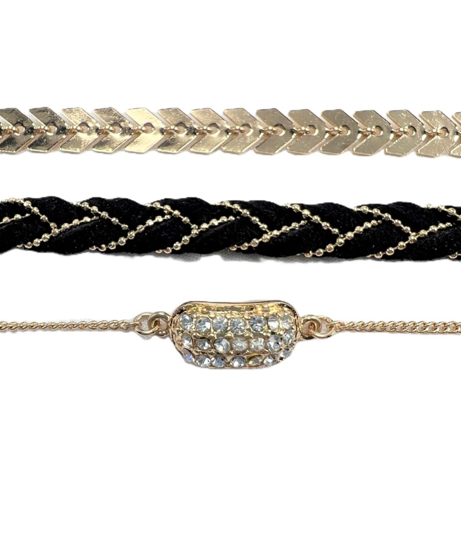 Three elegant bracelets featuring gold, black velvet, and rhinestones.