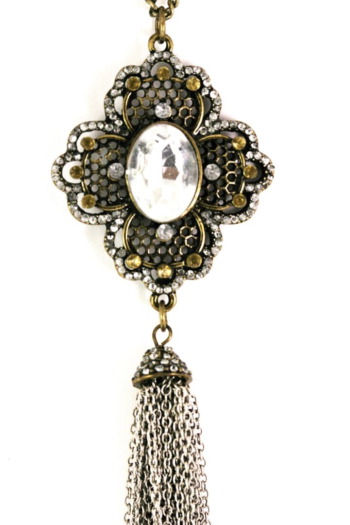 Vintage brooch with a cameo and dangling tassel.