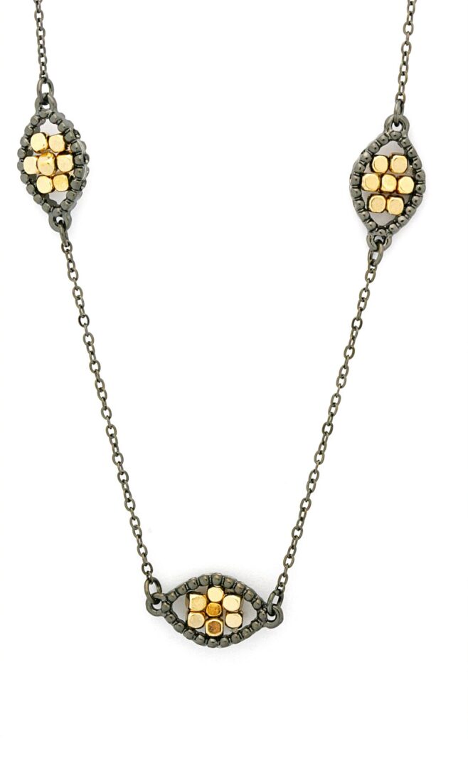 Antique-style necklace with floral motifs in gold and silver tones.