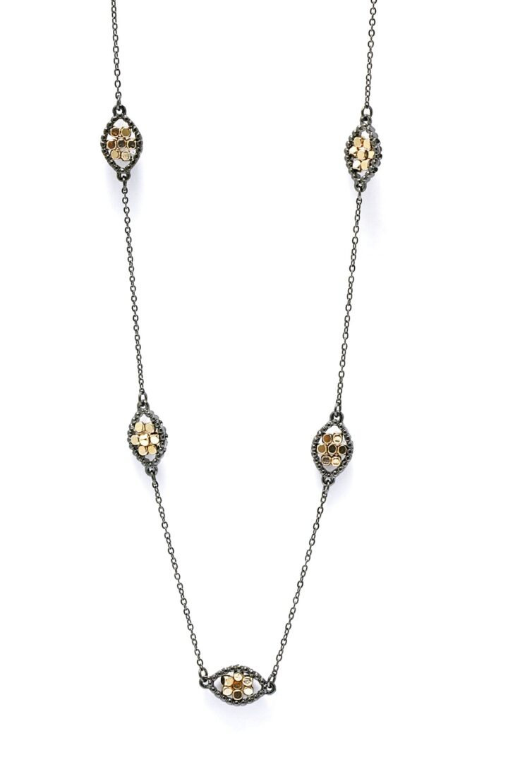 Elegant necklace with teardrop-shaped pendants adorned with gemstones.